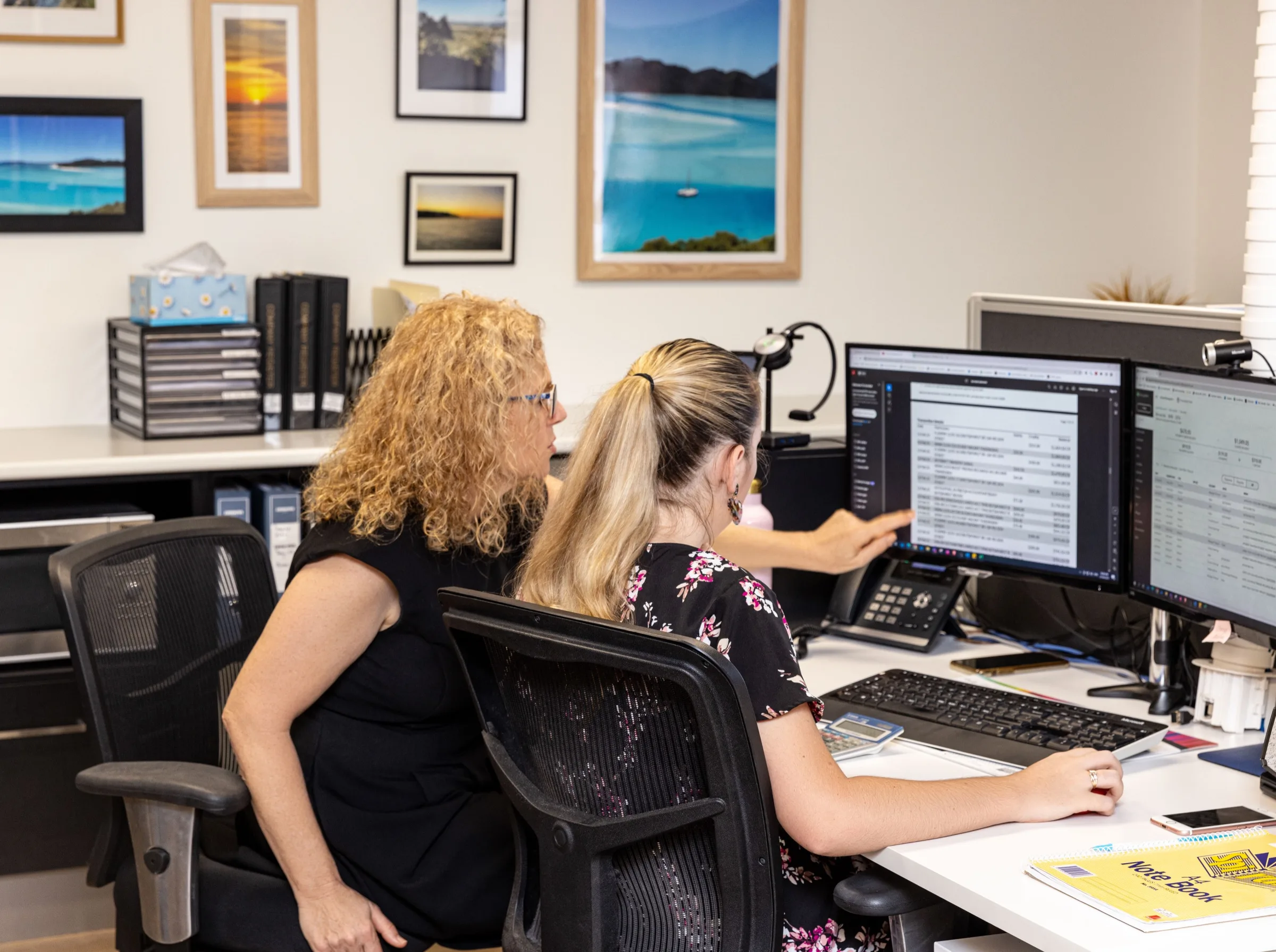 Two Ready Accounting team members reviewing account figures together on screen